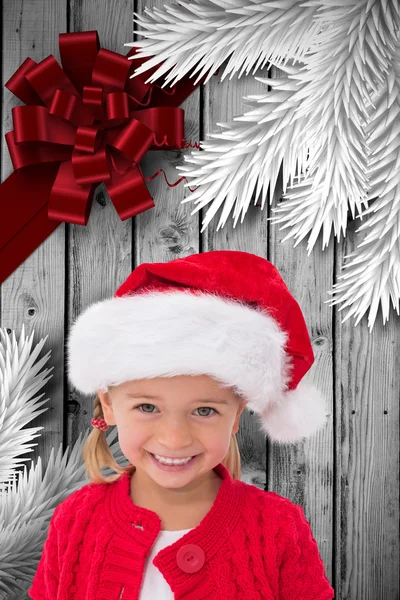 Imagen compuesta de linda niña usando sombrero de santa — Foto de Stock