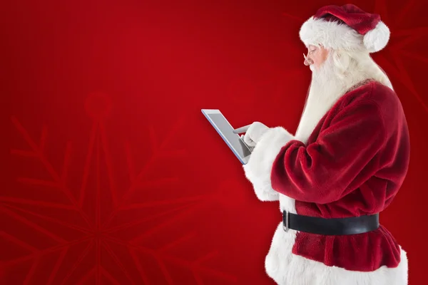 Santa uses a tablet PC — Stock Photo, Image