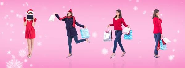 Composite image of festive brunette holding gift bags — Stock Photo, Image