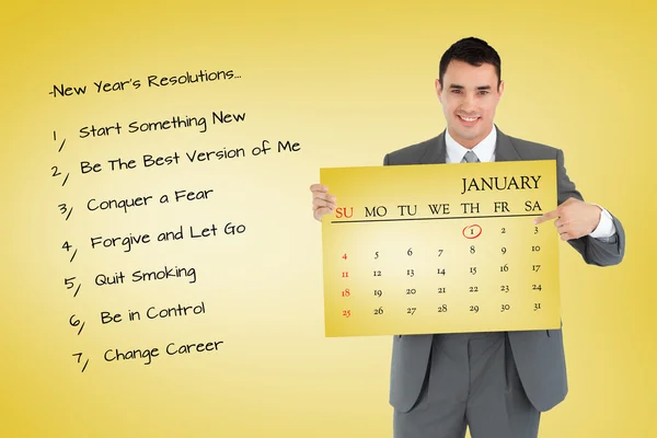 Businessman pointing at calendar he is holdin — Stock Photo, Image