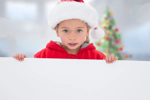 Composite image of festive little girl showing poster — Stock Photo, Image