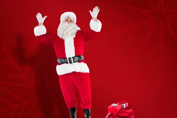 Σύνθετη εικόνα της ευτυχισμένη Άγιος Βασίλης με σάκο γεμάτο δώρα — Φωτογραφία Αρχείου