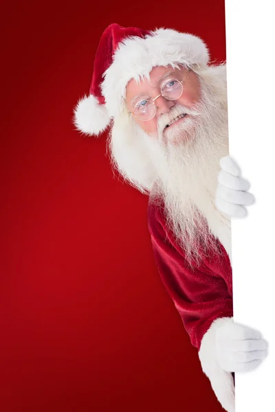 Santa looks out behind wall — Stock Photo, Image