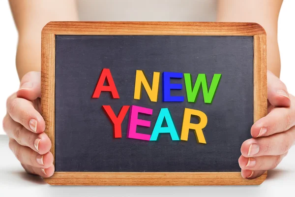 Composite image of females hands showing black board — Stock Photo, Image