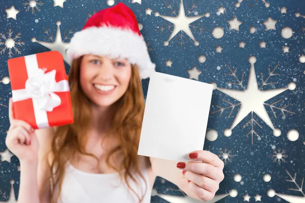 Festive redhead holding gift — Stock Photo, Image