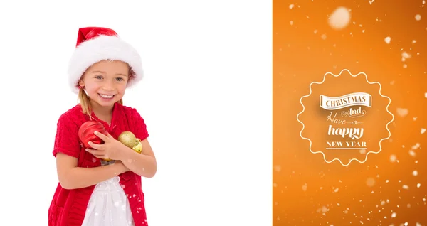 Liten flicka i santa hatt hålla grannlåt — Stockfoto