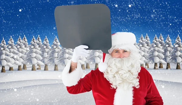 Happy santa claus holding speech bubble — Stock Photo, Image