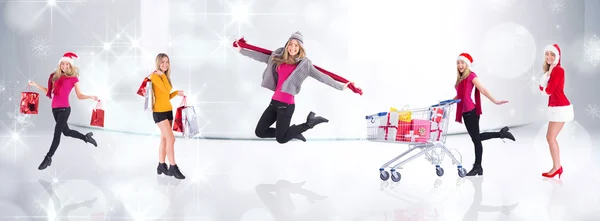 Festive blonde carrying gift bags — Stock Photo, Image