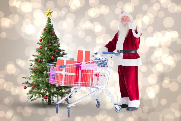 Santa spingendo un carrello della spesa — Foto Stock