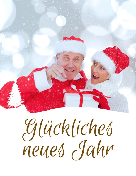 Festive mature couple holding gift — Stock Photo, Image