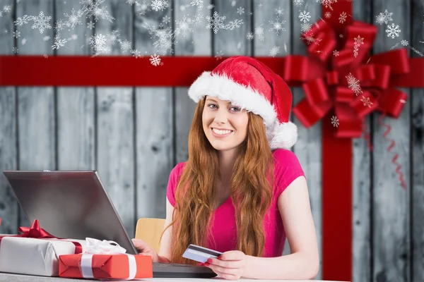 Festive redhead shopping online with laptop — Stock Photo, Image