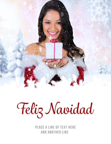 Composite image of pretty girl in santa outfit holding gift — Stock Photo, Image