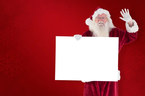 Papai Noel segura um sinal e está acenando — Fotografia de Stock