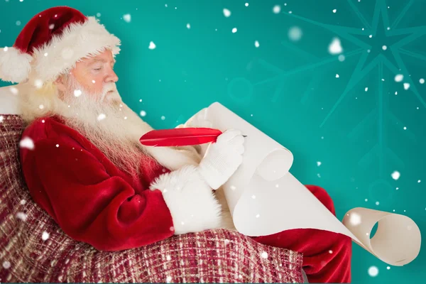Santa Claus psaní seznam s ostnem — Stock fotografie