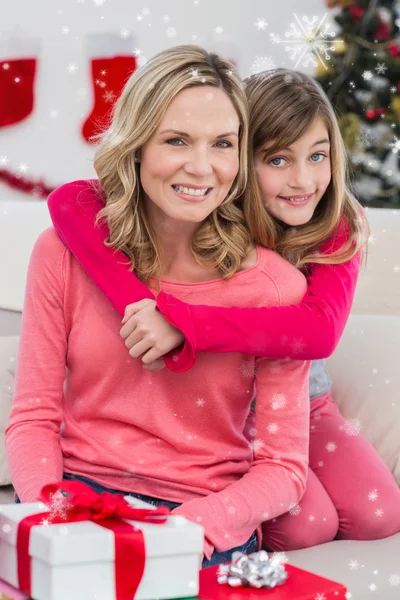 Festive mother and daughter smiling — Stock Photo, Image