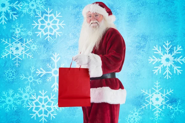 Santa draagt rode geschenk tas — Stockfoto