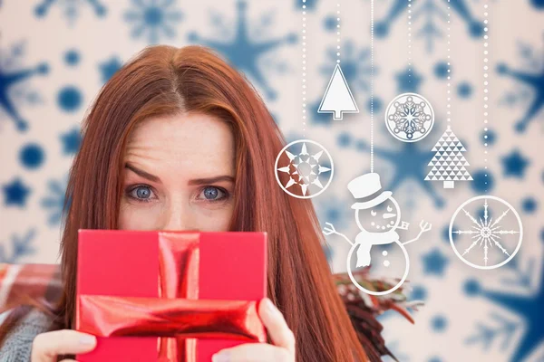Composite image of woman holding gift — Stock Photo, Image