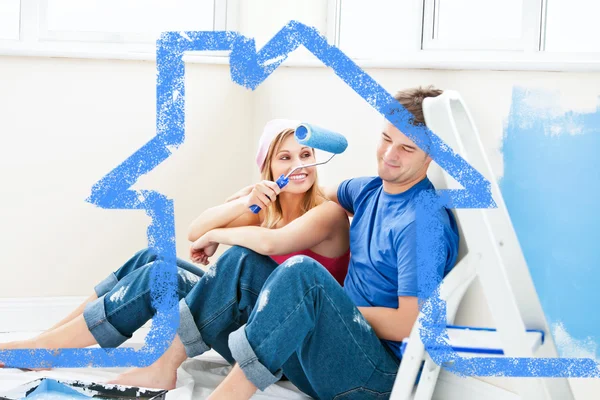 Charming couple relaxing after painting a roo — Stock Photo, Image