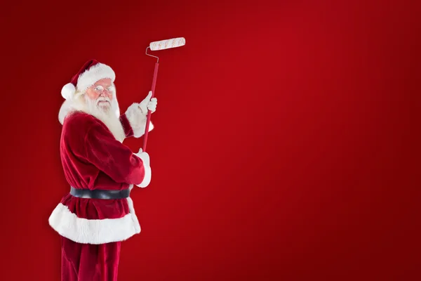 Father Christmas paints wall — Stock Photo, Image