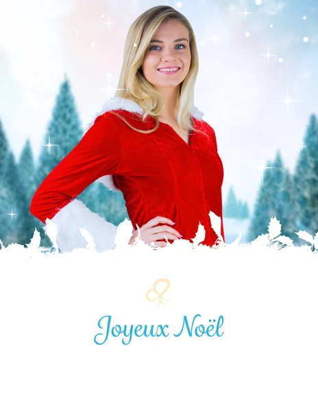 Composite image of pretty girl smiling in santa outfit — Stock Photo, Image