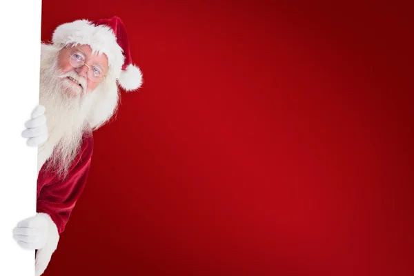 Santa ser ut bakom en vägg — Stockfoto