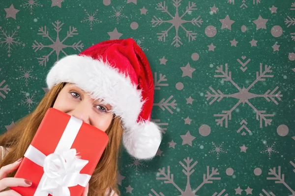 Festive redhead holding gift — Stock Photo, Image