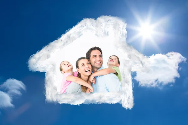 Happy young family looking up together — Stock Photo, Image