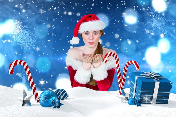 Girl in santa costume blowing — Stock Photo, Image