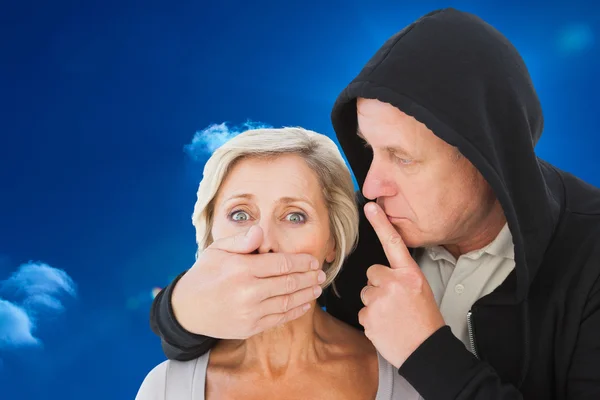 Older man silencing his fearful partner — Stock Photo, Image