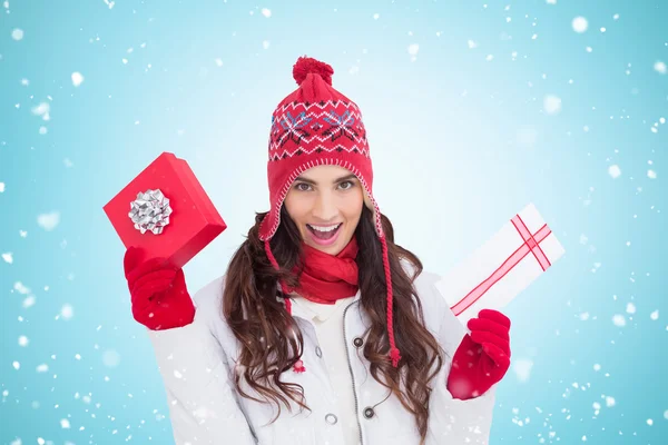 Festive brunette holding gifts — Stock Photo, Image