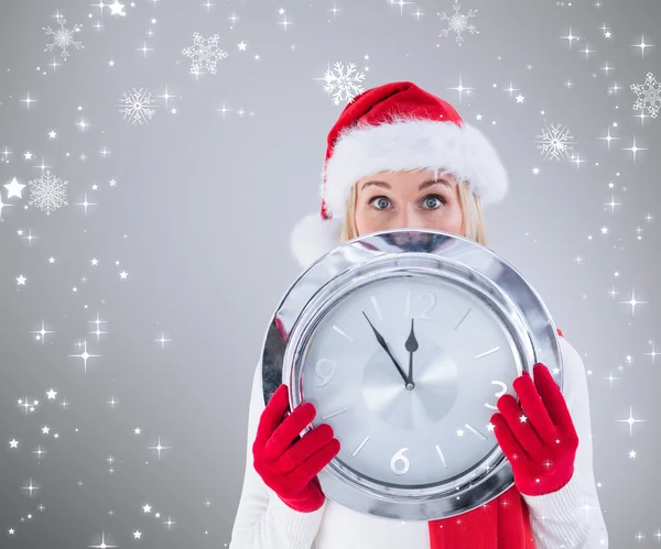 Festive blonde holding a clock — Stock Photo, Image