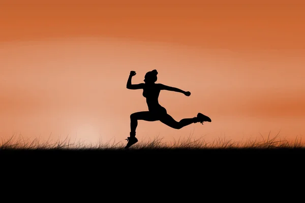 Fit brunette running against sun rising — Stock Photo, Image