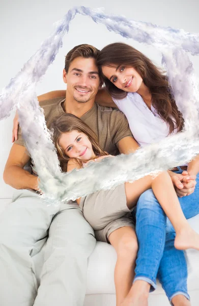 Cute family sitting together on a sofa — Stock Photo, Image