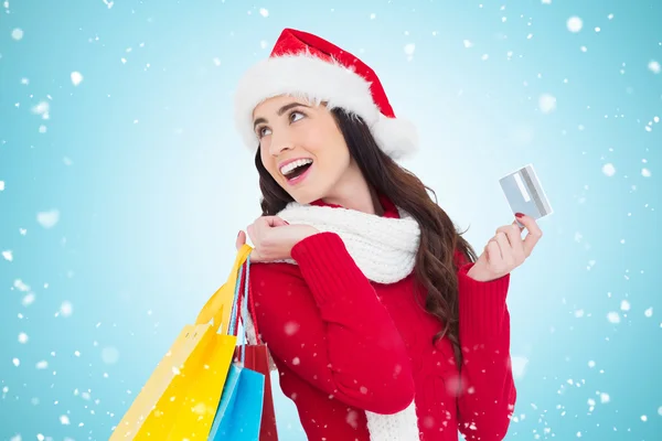 Brunette holding shopping bags and credit card — Stock Photo, Image