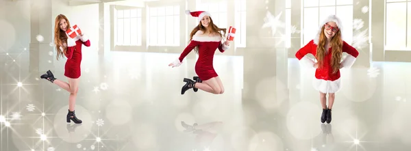 Festive redhead holding a gift — Stock Photo, Image