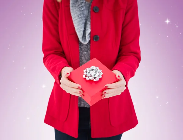 Festive blonde holding red gift — Stock Photo, Image