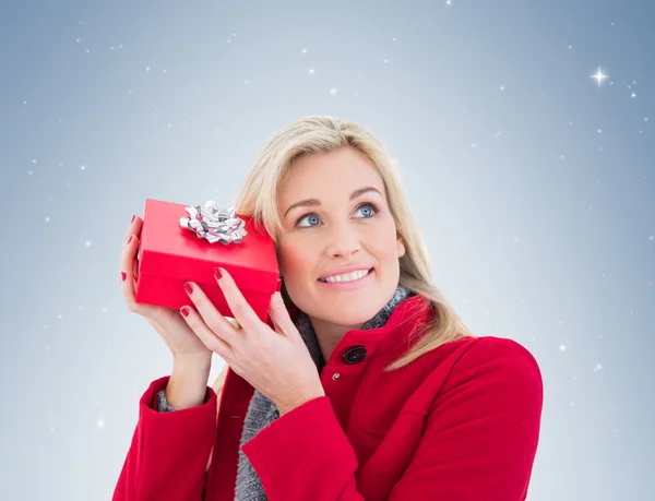 Festive blonde holding red gift — Stock Photo, Image