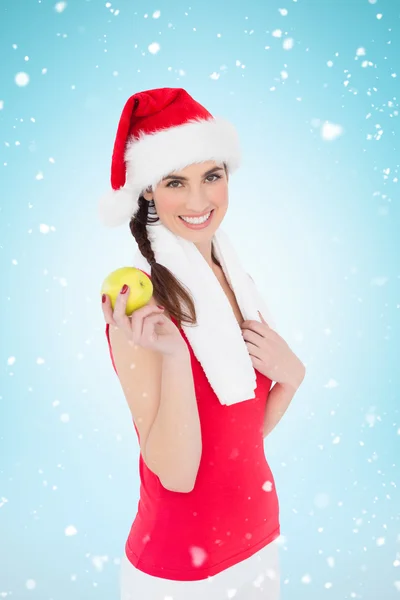 Feestelijke fit brunette bedrijf apple — Stockfoto