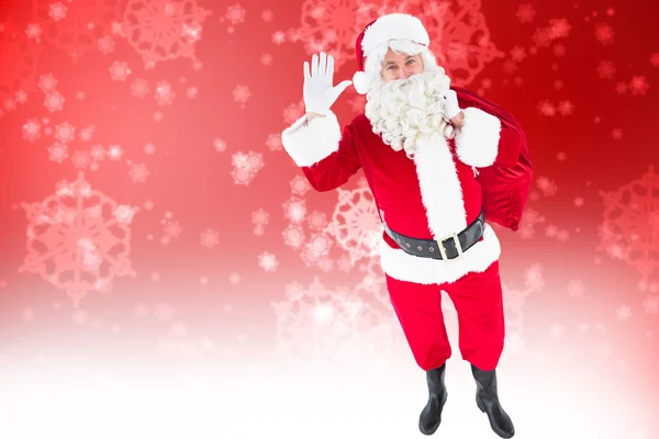 Santa holding a sack and waving — Stock Photo, Image