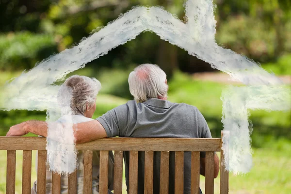 Composite image of couple sitting on the bench