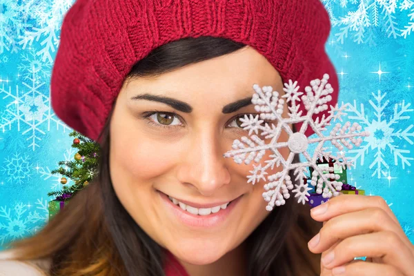 Brunette in hat holding snowflake — Stock Photo, Image