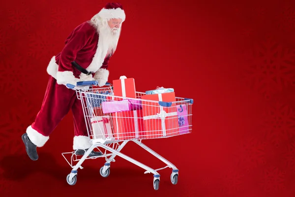 Santa rijdt op winkelwagen — Stockfoto