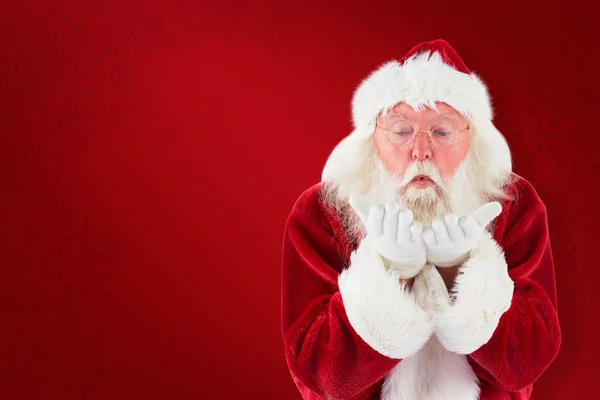 Santa Claus blows something away — Stock Photo, Image