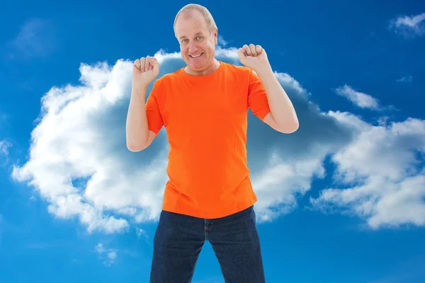 Mature man in orange tshirt cheering — Stock Photo, Image