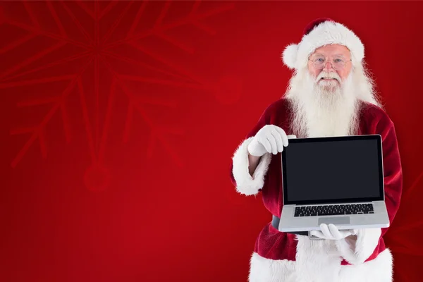 Santa Claus prezentuje laptopa — Zdjęcie stockowe