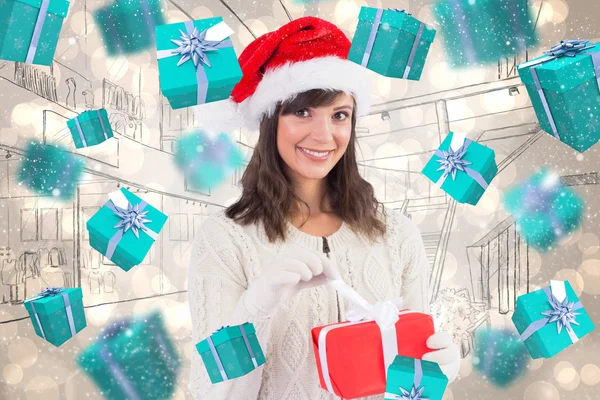 Smiling young woman in santa hat opening — Stock Photo, Image