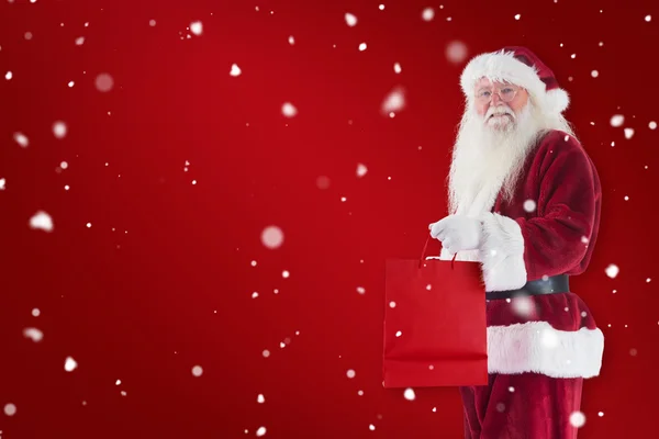 Santa carries red gift bag — Stock Photo, Image