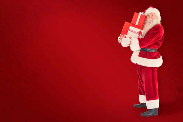Noel Baba bir kaç hediye taşır — Stok fotoğraf