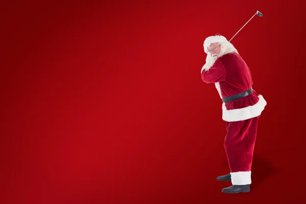 Santa Claus swings his golf club — Stock Photo, Image