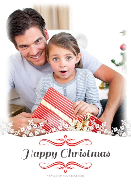 Surprised girl holding Christmas present — Stock Photo, Image